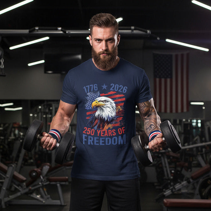 Man lifting weights in a gym wearing a t-shirt with an eagle design and text.