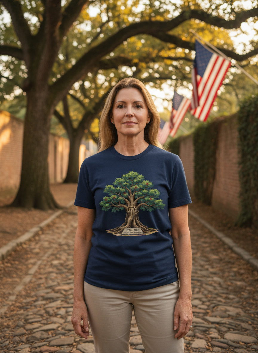 Woman wearing a blue t-shirt with a tree design outdoors on a stone path.